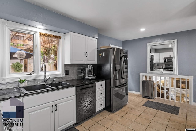 kitchen featuring sink, stainless steel appliances, light tile patterned floors, backsplash, and white cabinets