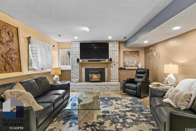 living room featuring a fireplace and a textured ceiling