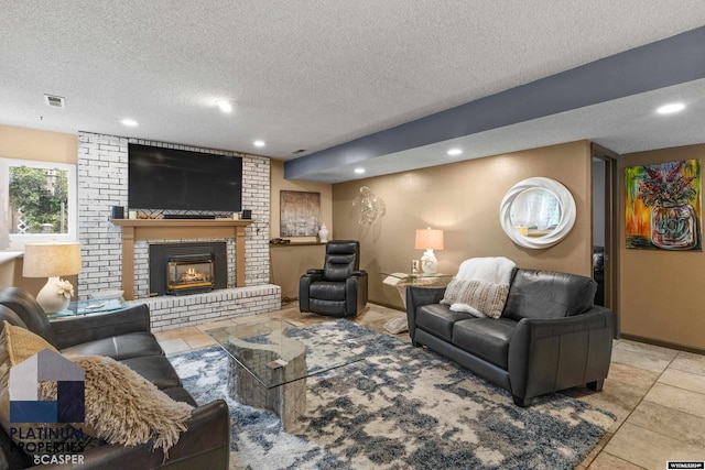 living room featuring a textured ceiling and a brick fireplace