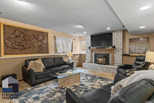 living room featuring light tile patterned floors, a textured ceiling, and a brick fireplace