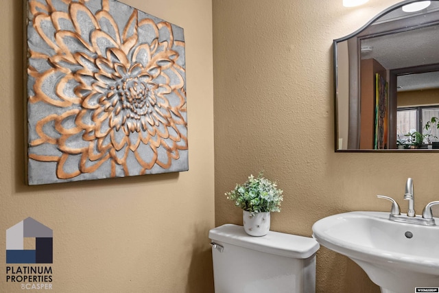 bathroom featuring toilet and sink