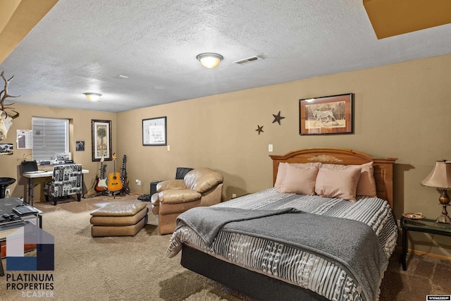 bedroom with carpet and a textured ceiling