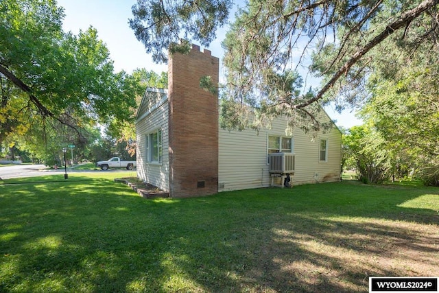 back of property with a lawn and central air condition unit