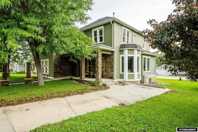 view of front of home featuring a front lawn and a garage