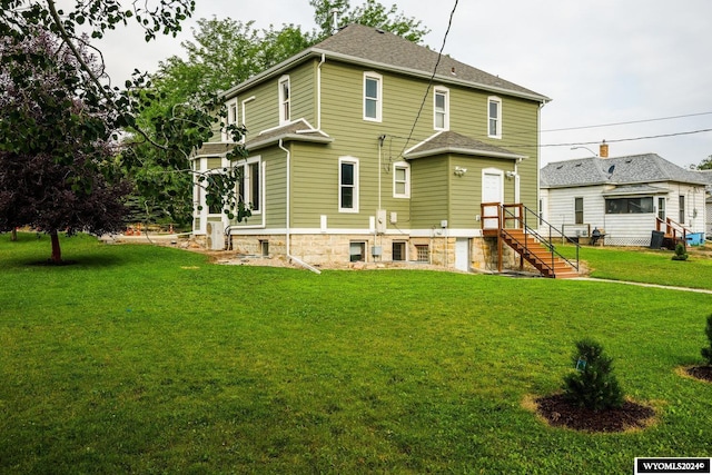 rear view of house with a yard