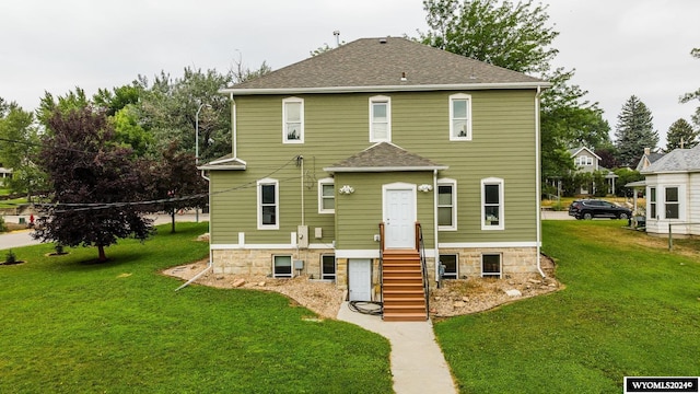 back of house with a lawn