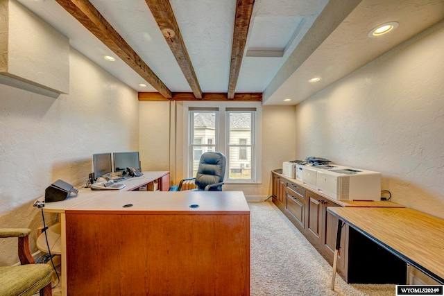 office space featuring light carpet and beam ceiling