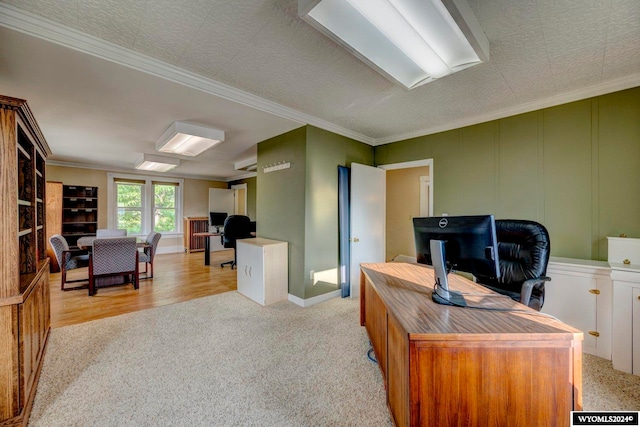 office space featuring crown molding, a textured ceiling, and light hardwood / wood-style flooring