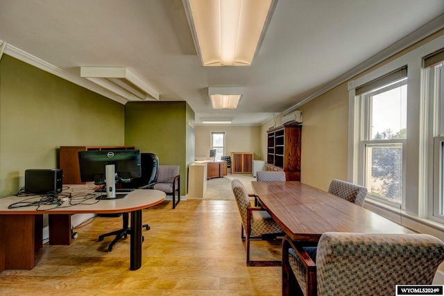 office featuring a wall unit AC, light hardwood / wood-style floors, and ornamental molding