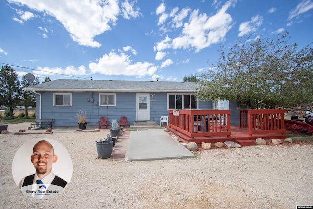 back of house with a wooden deck