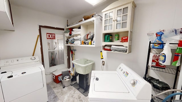 clothes washing area with washing machine and dryer