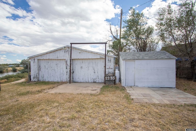 view of outdoor structure featuring a lawn