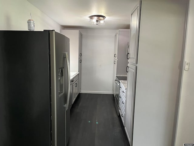 kitchen with white cabinets, dark hardwood / wood-style floors, and stainless steel fridge with ice dispenser