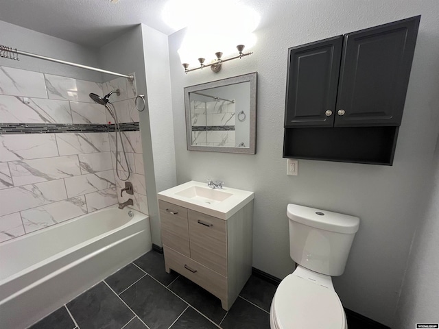 full bathroom featuring tile patterned floors, tiled shower / bath combo, vanity, and toilet