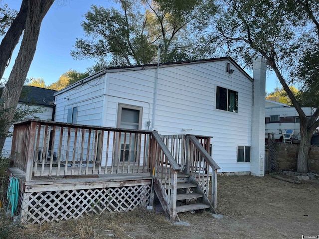 rear view of property with a wooden deck