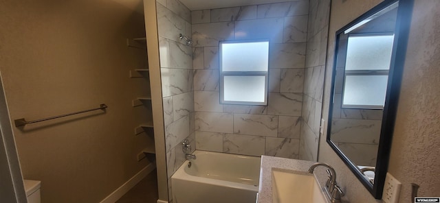 bathroom featuring a wealth of natural light, shower / tub combination, and vanity