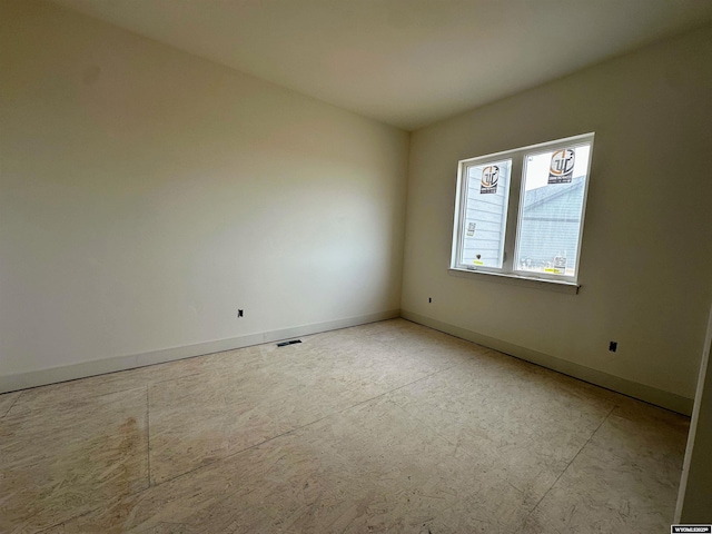 spare room with visible vents and baseboards