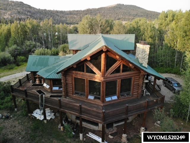 rear view of house with a deck with mountain view