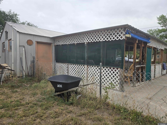 view of side of property featuring metal roof