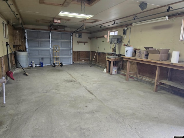 garage with a garage door opener and water heater