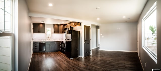 kitchen featuring black appliances, sink, and dark wood-type flooring