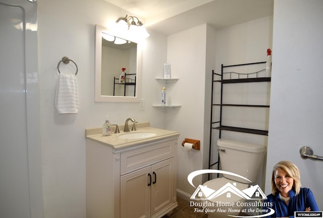 bathroom featuring vanity, toilet, and tile patterned floors