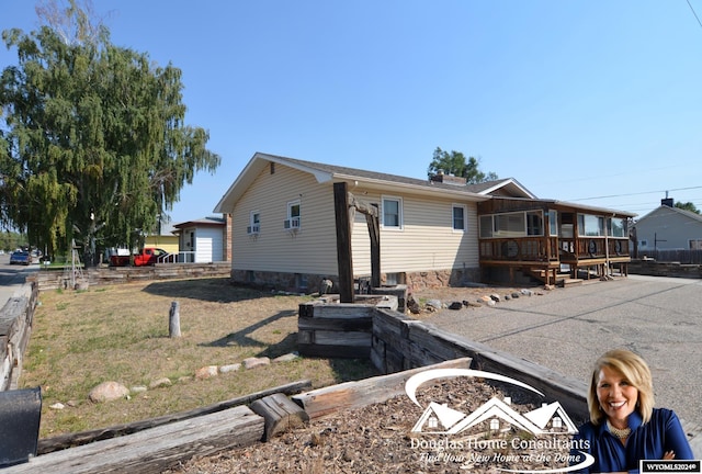 view of front of house with a front lawn, a patio area, and an outdoor fire pit