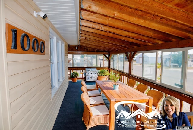 sunroom with wood ceiling and vaulted ceiling with beams