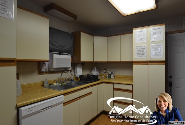 kitchen featuring cream cabinetry, backsplash, dishwasher, light hardwood / wood-style flooring, and sink