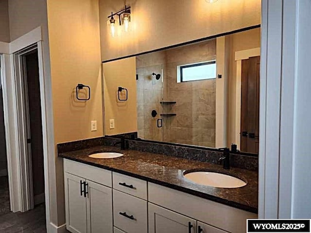 bathroom featuring vanity and tiled shower