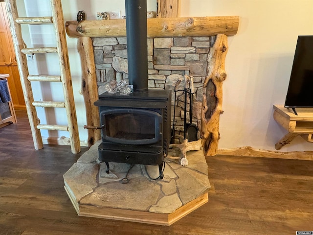 interior details with wood-type flooring and a wood stove