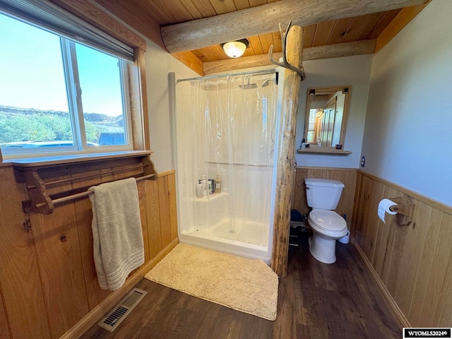 bathroom with hardwood / wood-style flooring, toilet, and a shower with shower curtain