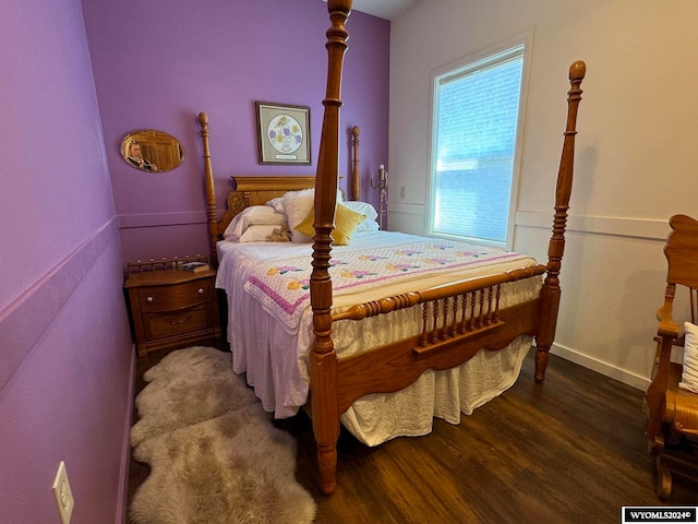 bedroom with dark hardwood / wood-style flooring