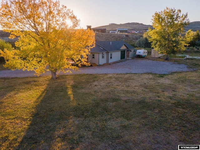 yard at dusk with a mountain view and a patio area