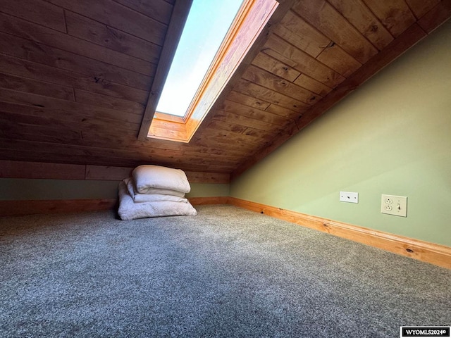 bonus room featuring vaulted ceiling with skylight, wood ceiling, and carpet flooring