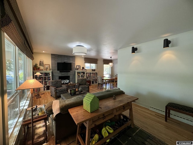 living room with a large fireplace and wood-type flooring