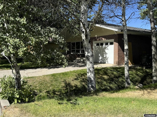 view of front of house with a garage and a front yard