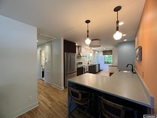 dining area featuring light wood-type flooring and sink