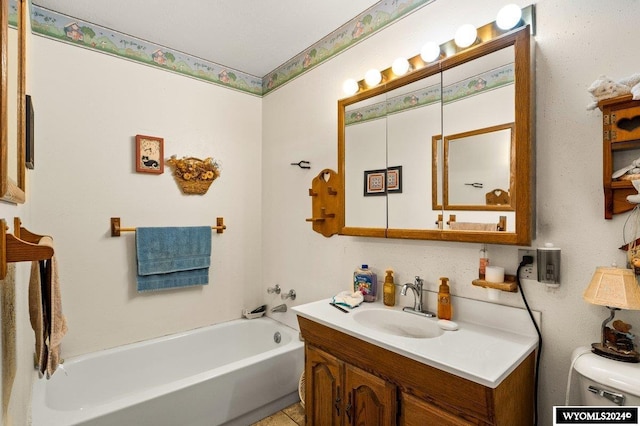 2226 E I St, Torrington, WY 82240 - bathroom featuring vanity, a tub to relax in, and toilet