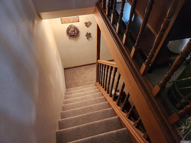 2226 E I St, Torrington, WY 82240 - staircase featuring carpet, a textured wall, and baseboards