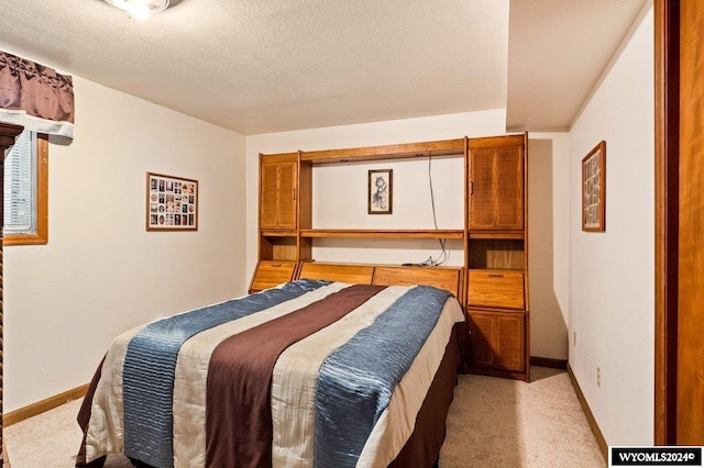 2226 E I St, Torrington, WY 82240 - bedroom with light carpet, baseboards, and a textured ceiling
