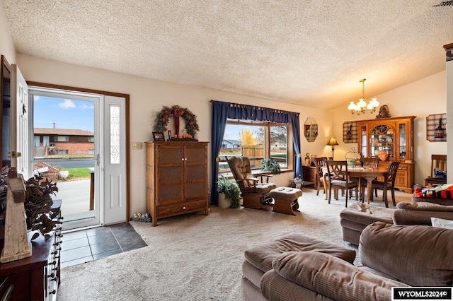 2226 E I St, Torrington, WY 82240 - living room with a chandelier, carpet, a textured ceiling, vaulted ceiling, and tile patterned flooring