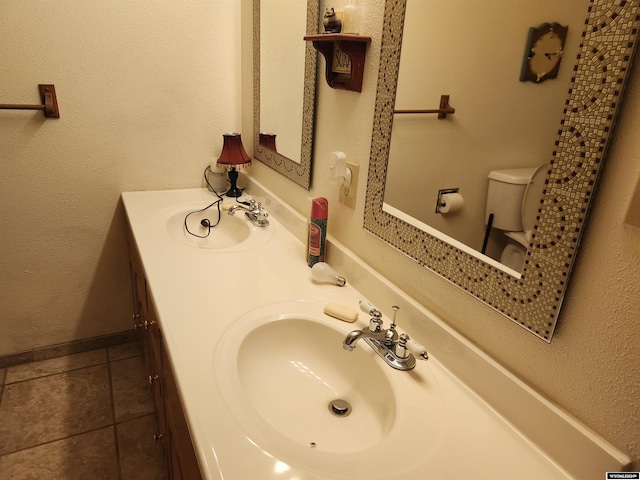 bathroom featuring toilet, vanity, and tile patterned floors