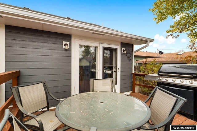 2226 E I St, Torrington, WY 82240 - wooden terrace featuring outdoor dining area and a grill