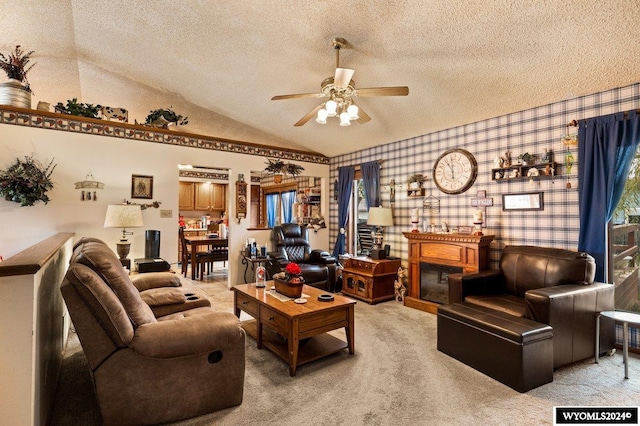 carpeted living room featuring a textured ceiling, ceiling fan, and vaulted ceiling