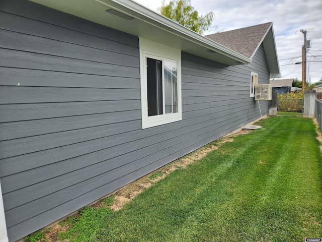 view of side of property with a yard