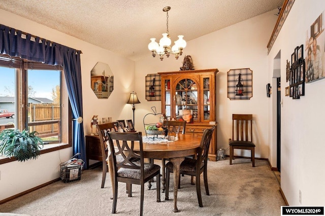 2226 E I St, Torrington, WY 82240 - carpeted dining area with vaulted ceiling, a chandelier, a textured ceiling, and baseboards