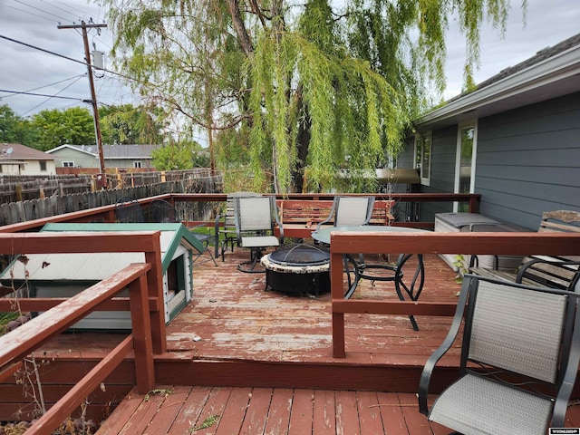 wooden terrace featuring an outdoor fire pit