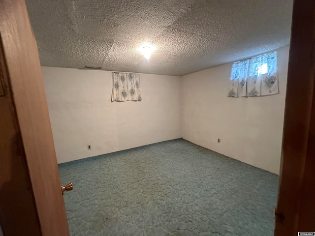 basement with a textured ceiling and carpet