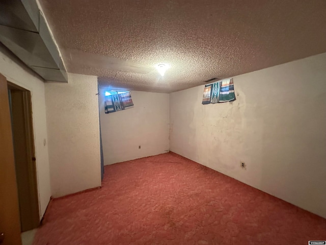 basement with a textured ceiling and carpet